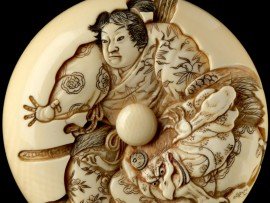 Detail of a manju netsuke depicting Minamoto Yoshitsune practising martial arts with a tengu demon, 