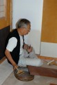 Paperer Tago Yūji at work on the tea house walls. © Ashmolean Museum, University of Oxford