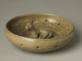 Greenware burial figure of dog in a pen