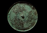 Ritual mirror with interlaced dragons on a geometric ground