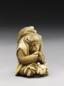 Netsuke in the form of a monkey holding a crab