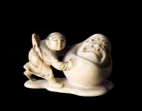 Netsuke in the form of a boy rolling a yuki daruma, or snowman (EA1956.1738)