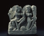 Relief depicting two deities with a staff, purse, and cornucopia (EA1962.42)