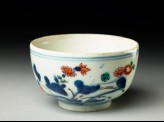 Cup with prunus and flowering plant