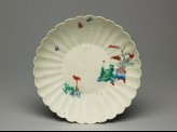 Fluted saucer depicting a boy, probably trying to catch a bird