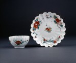 Fluted cup and saucer with floral decoration
