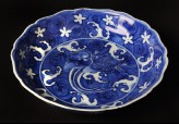 Blue-and-white dish with animals amid waves