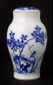 Blue-and-white jar and lid with birds, rocks, and plants