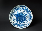 Blue-and-white dish with basket of flowers