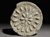 Circular roof end-tile with floral decoration (EA1983.234)