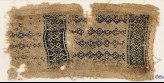 Textile fragment with linked diamond-shapes, hooks, squares, and crosses