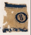 Textile fragment with circle and pseudo-inscription