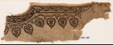 Textile fragment from the neck of a garment with vines and leaves