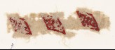 Textile fragment with lozenges and inscription
