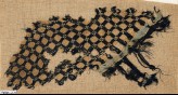 Textile fragment with grid and swastikas