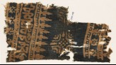 Textile fragment with Arabic-style script, rosettes, and stylized trees or foliage