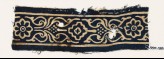 Textile fragment with rosettes, stylized leaves, and a diamond-shape
