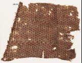Textile fragment with linked hexagons and rosettes, probably from a garment (EA1990.477)