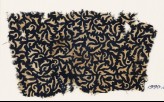 Textile fragment with swirling leaves