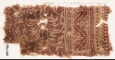 Textile fragment with swirling flower-heads and a dotted zigzag (EA1990.540)