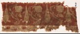 Textile fragment with large flowers, undulating stems, and possibly stylized leaves