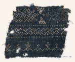 Textile fragment with dots arranged in geometric patterns