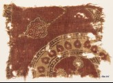 Textile fragment with part of a large circle and leaves