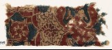 Textile fragment with medallion, wings, and rosettes