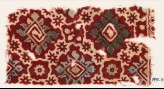 Textile fragment with ornate squares, stars, and flowers