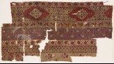Textile fragment with bands of carnations, grapes, and flower-heads (EA1990.1235)