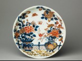 Saucer with flowers on a terrace