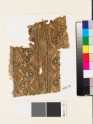 Textile fragment with bands of curving lines and floral trefoils