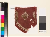 Textile fragment from a tab with a cross, shield-shape, and linked crosses (EA1993.241)