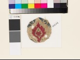 Roundel textile fragment with stylized leaf