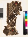 Textile fragment from the neck of a garment with hooks and diamond-shapes