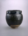 Black ware jar with white stripes