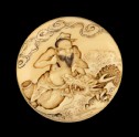 Manjū netsuke depicting the Daoist immortal Bashikō performing acupuncture on a dragon