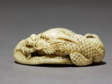 Netsuke in the form of a dragon coiled around a bowl