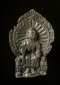 Seated figure of the Buddha with attendants
