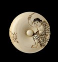 Manjū netsuke depicting a boy chasing away two oni, or demons