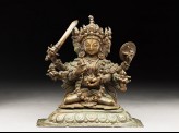 Seated figure of a multi-headed and multi-armed crowned female deity