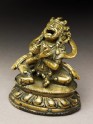 Seated figure of a male deity holding a bell and vajra, his head cocked back and mouth open, possibly an incense burner or pill dispenser