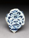 Base fragment with floral decoration in blue on white