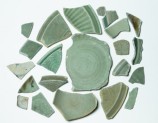 Group of greenware sherds with one blue and white fragment