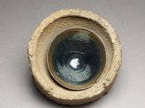 Black ware tea bowl stuck in its firing saggar (EAX.1580)