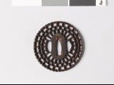 Round tsuba with radiating floral design
