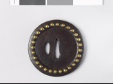 Round tsuba with brass studs