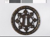 Round tsuba with karakusa, or scrolling plant pattern, interspersed with aoi, or hollyhock leaves