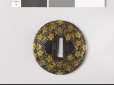 Round tsuba with karakusa, or scrolling floral pattern