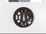 Round tsuba with flowers and a conch shell